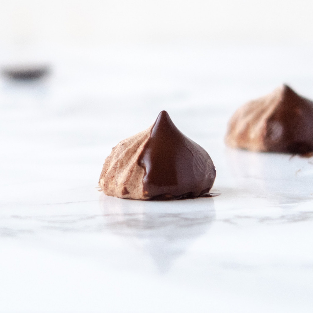 Vegan chocolate meringue kisses dipped in chocolate