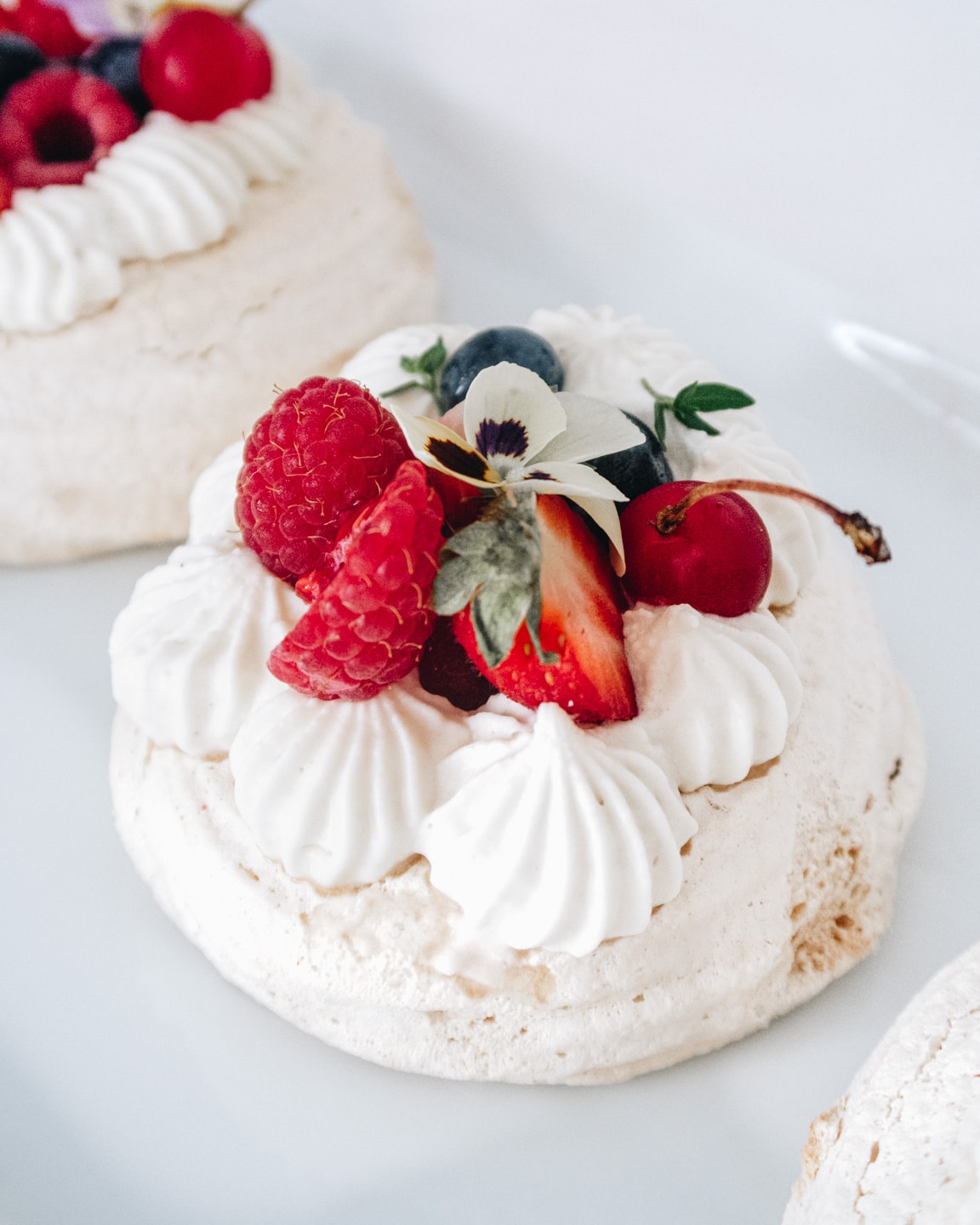 mini pavlova garnished with fresh fruits