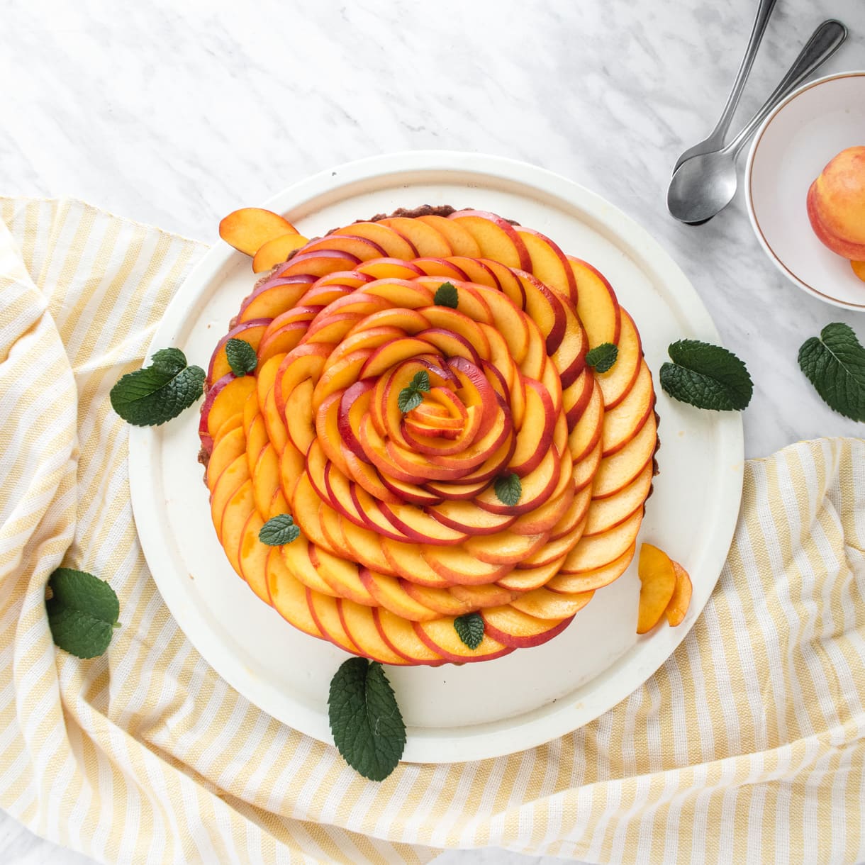 top down view of a vegan tart garnished with nectarines garnished as a rose