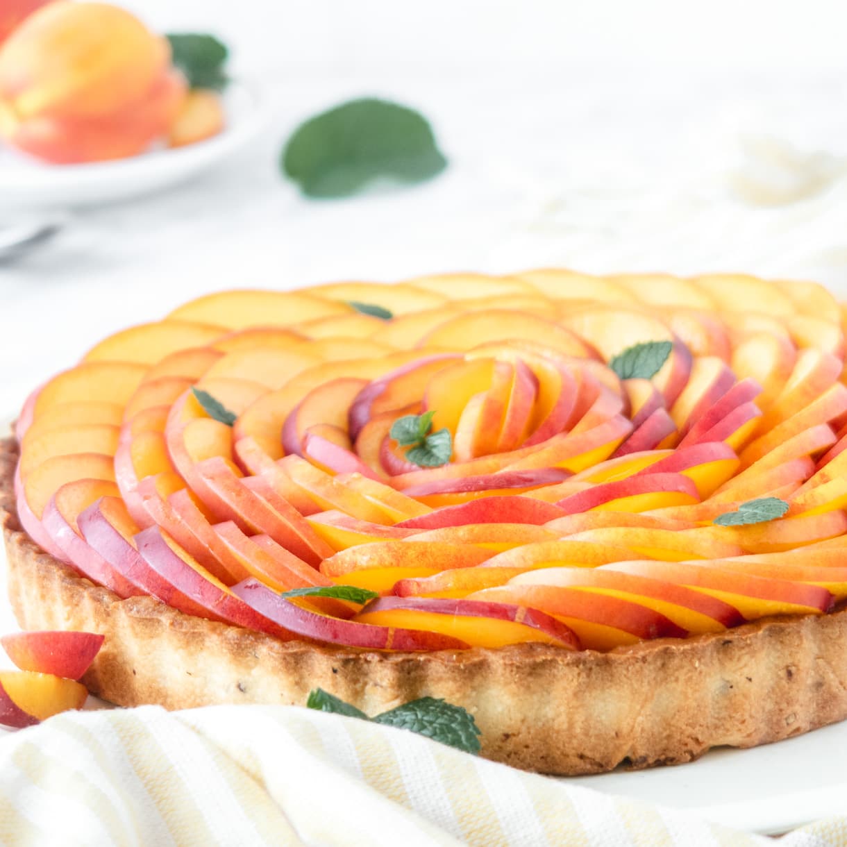 Close up of the nectarine rose tart garnish form the side