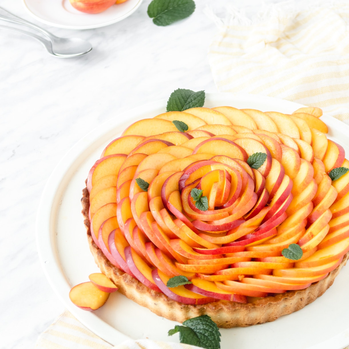 Vegan fresh nectarine tart ona white backgorund