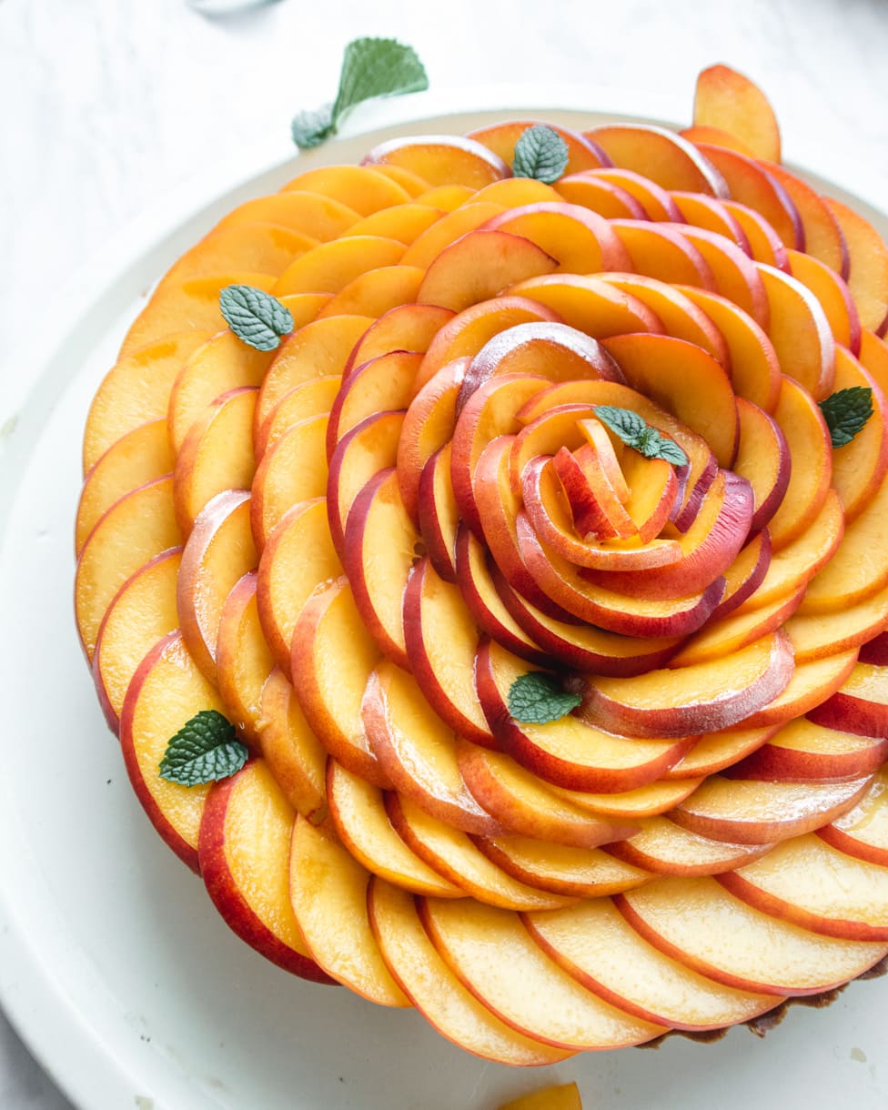 nectarine rose tart where the edge of the nectarine petals are painted gold