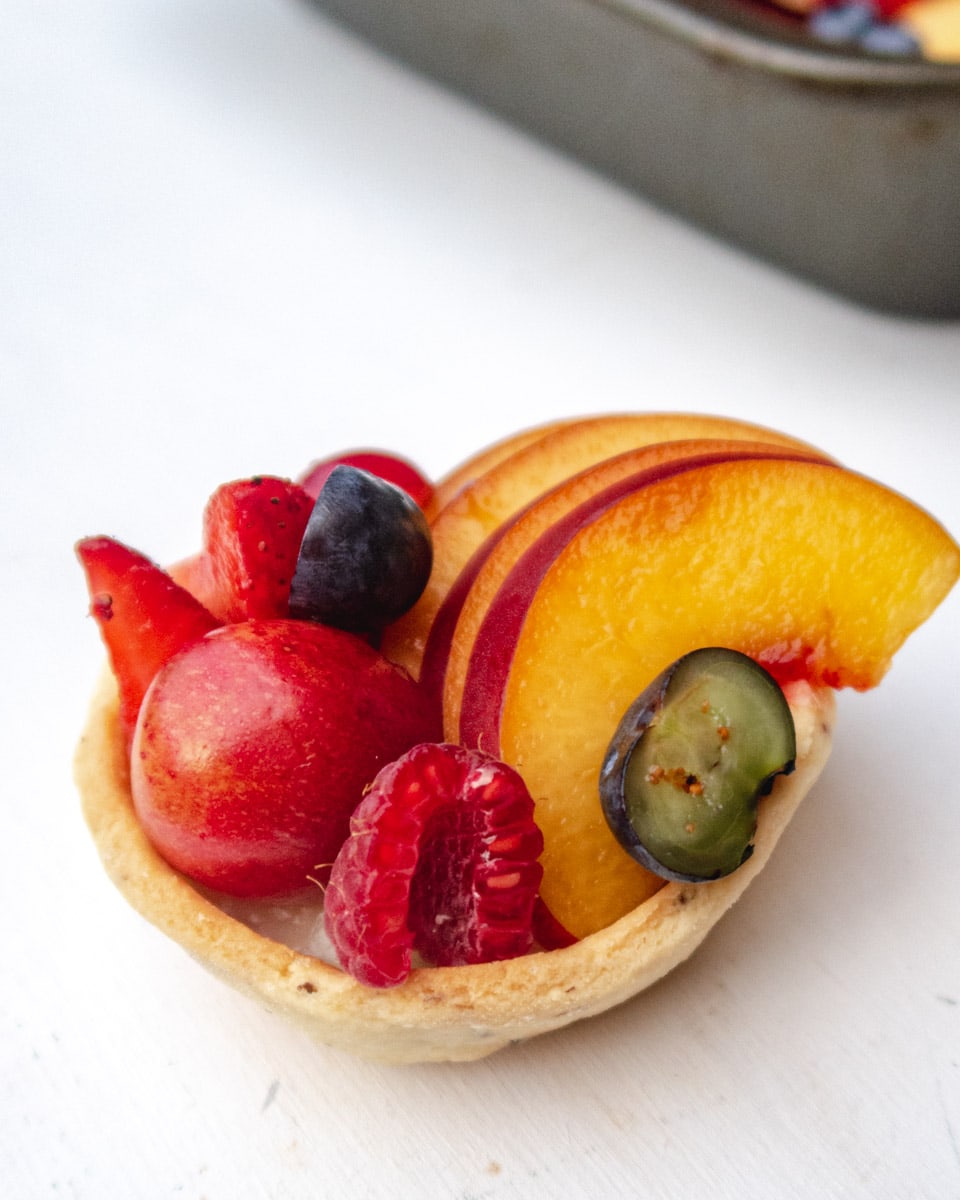 close up of a fresh fruit and custard tartlet