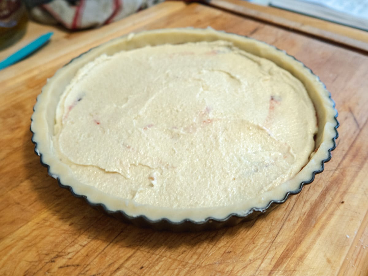 raw tart that is filled with frangipane cream