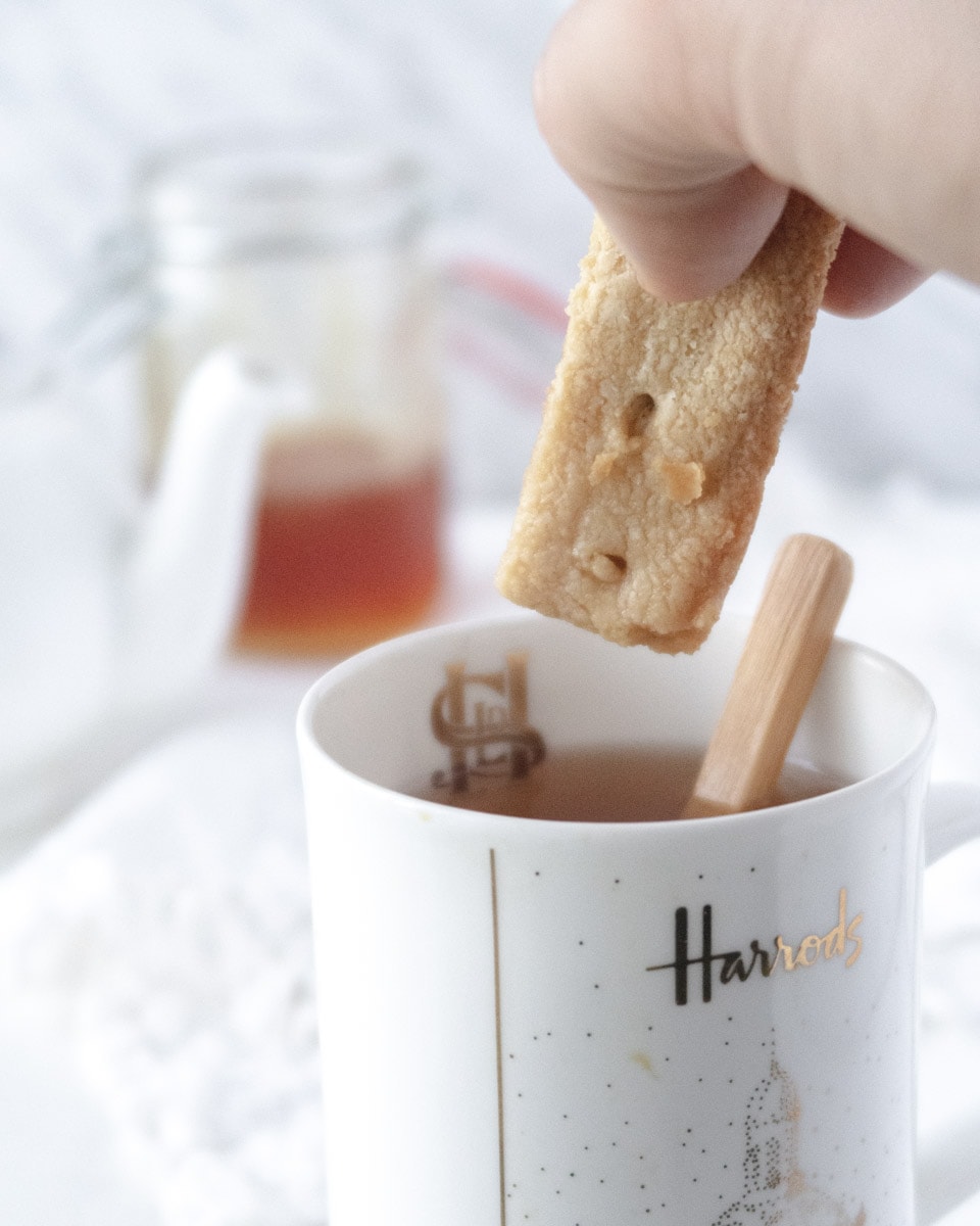 gluten-free shortbread being dipped in a cup of tea