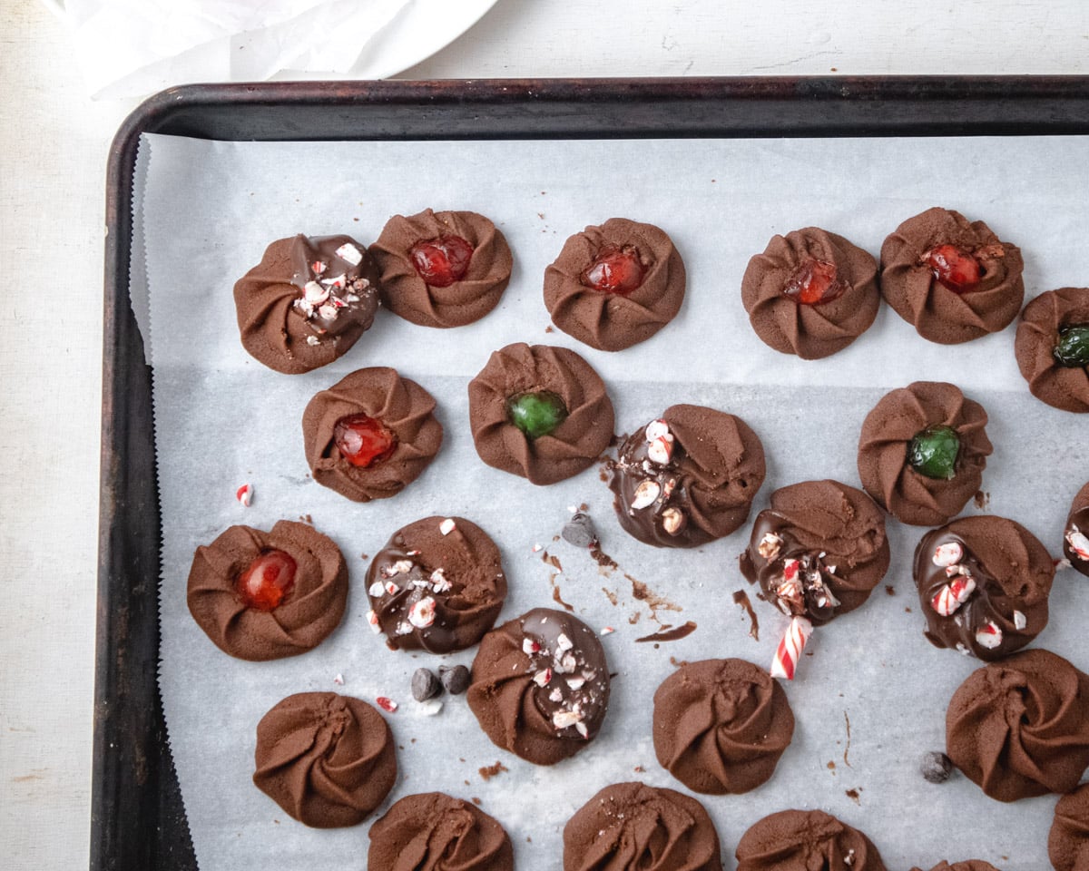 A variety of chocolate butter cookies on a baking tray