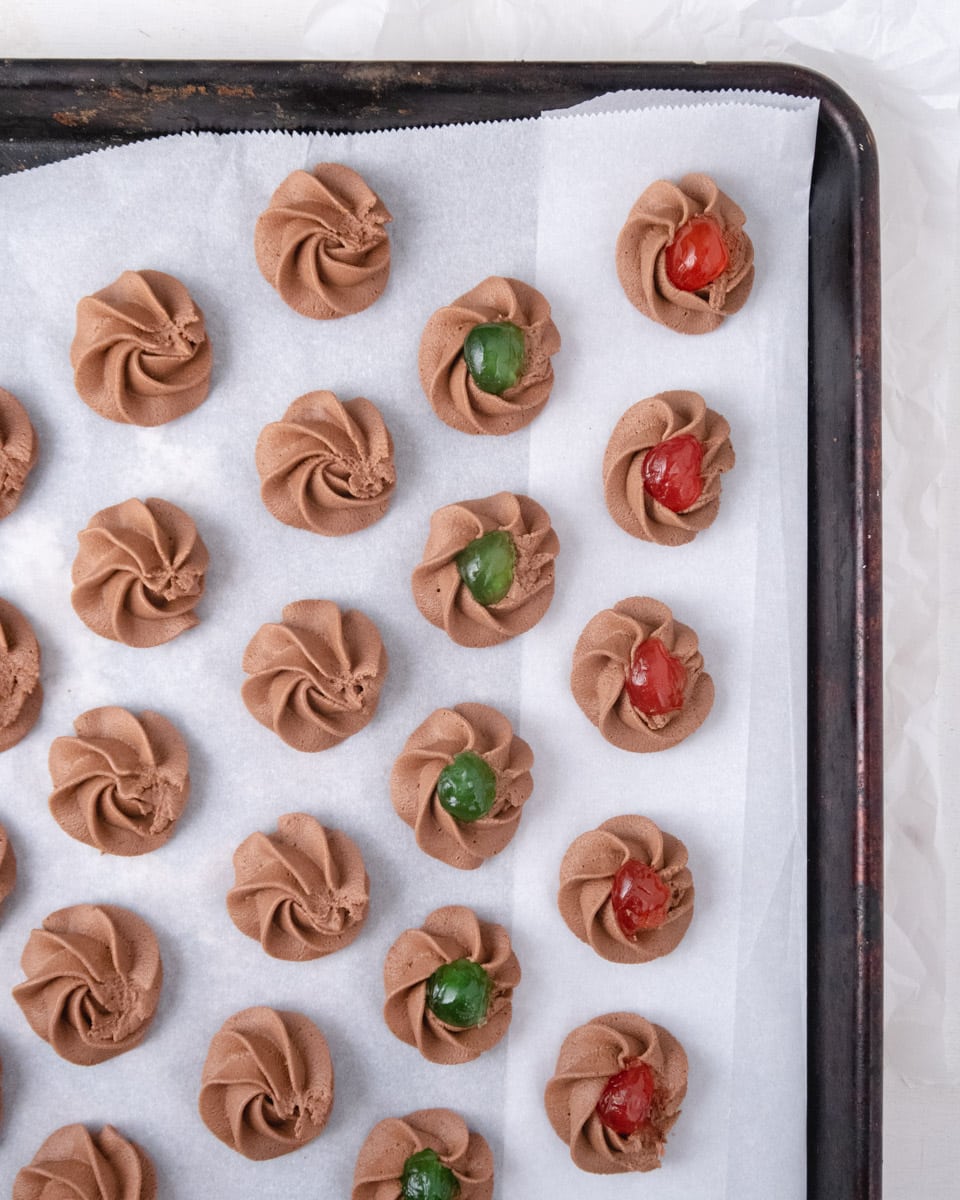 Piped unbaked cookie dough on a baking tray