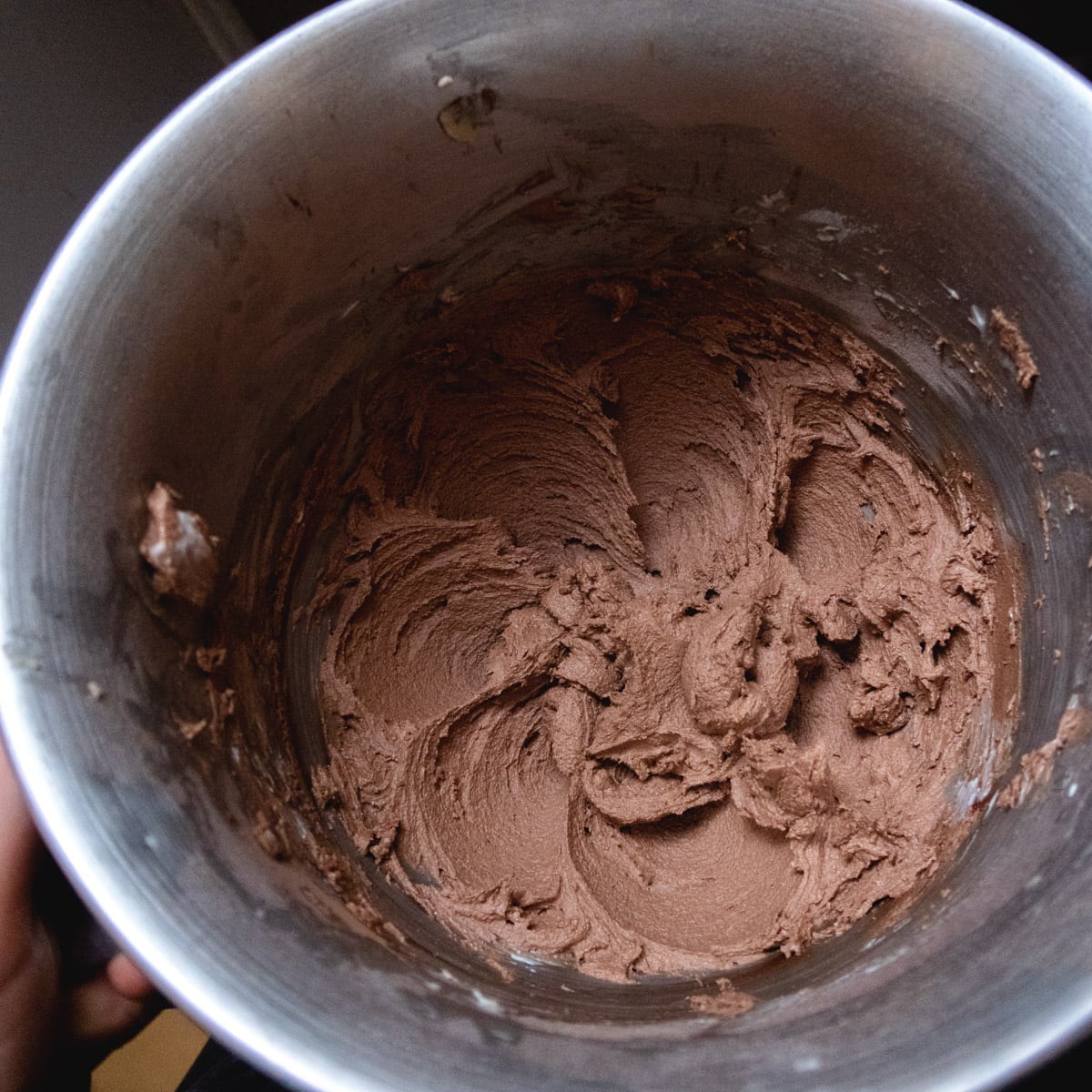top view of a chocolate butter cookie batter in a stand-mixer bowl
