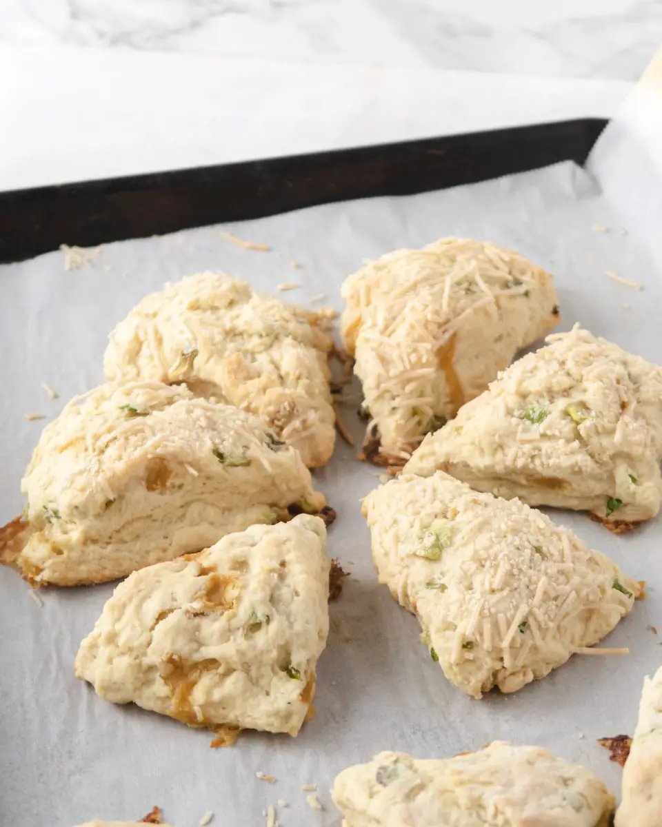 side view of scones placed in a circle on a parchment paper lined baking tray
