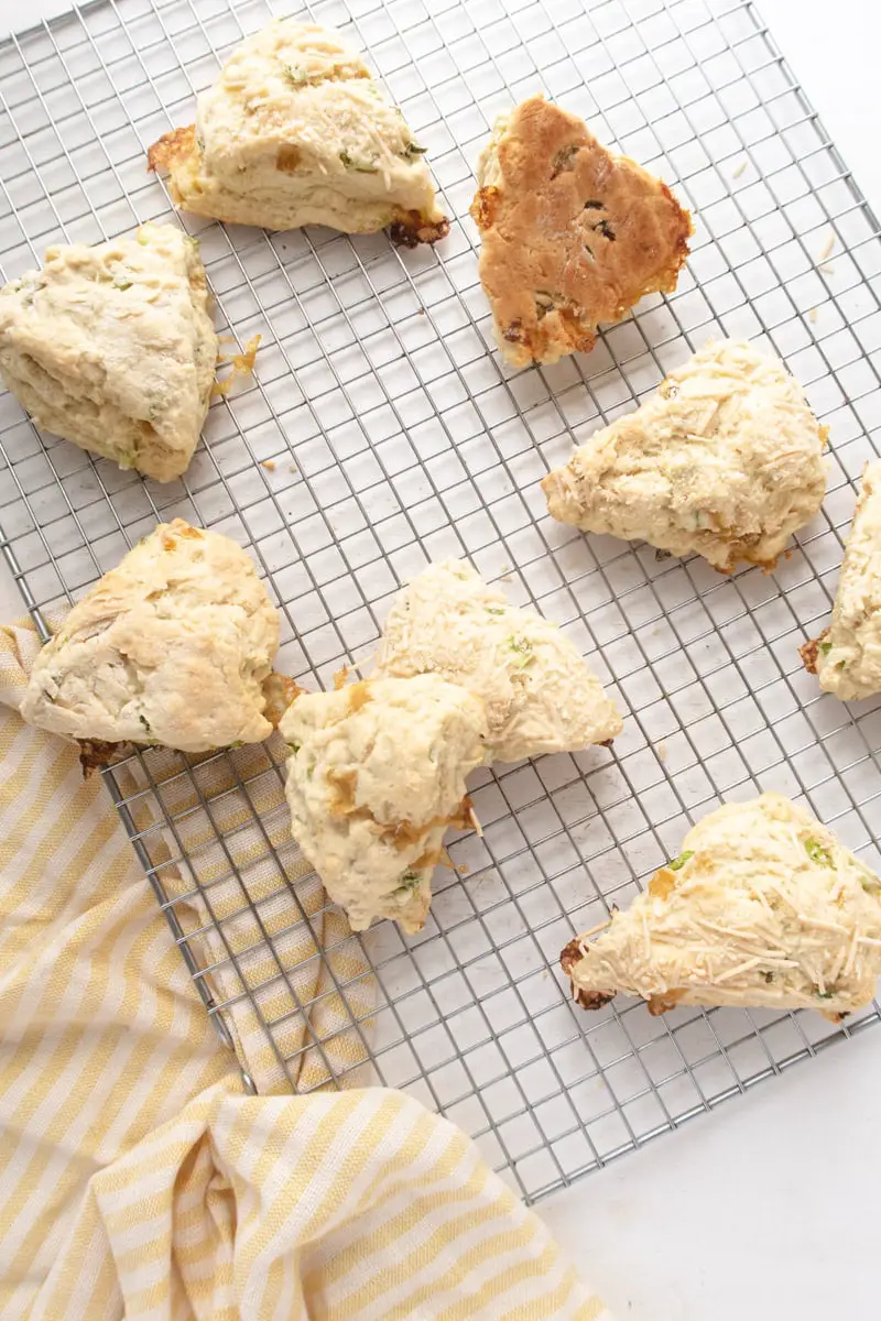 9 vegan scones placed randomly on a on a wirer cooling rack