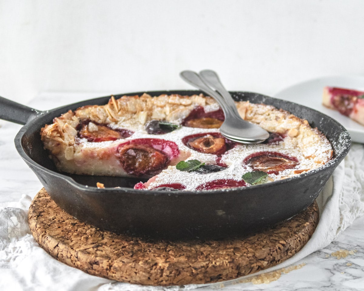 Side view of a clafoutis with a slice cut out