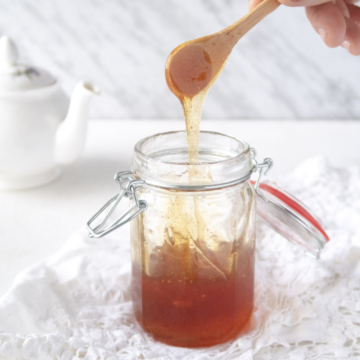 bee-free vegan honey dripping from a spoon into a jar