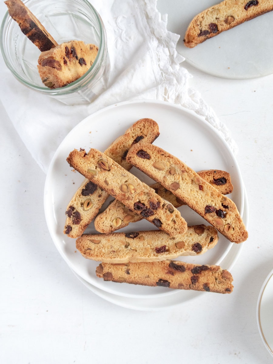 pile of vegan pistachio biscotti on a white plate