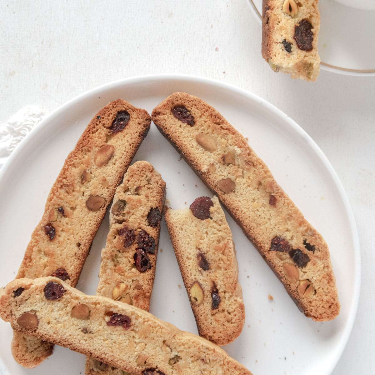 pile of vegan pistachio biscotti on a white plate