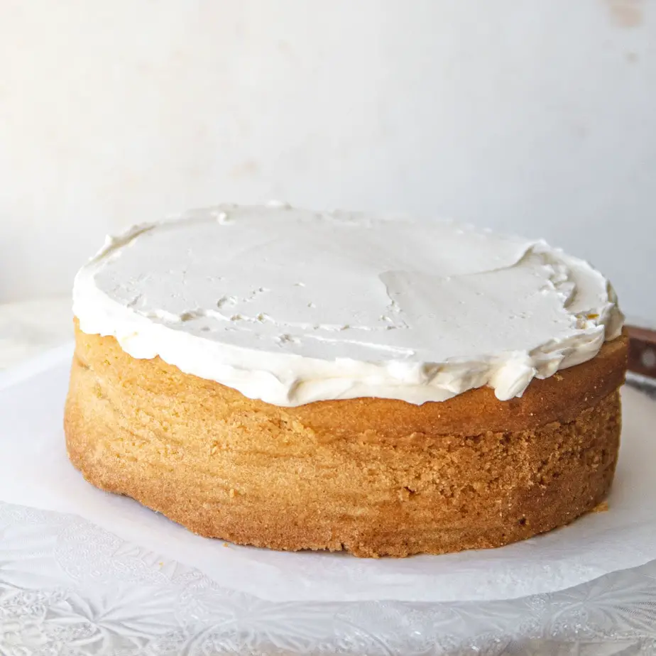 cake in the process of being filled with vanilla buttercream