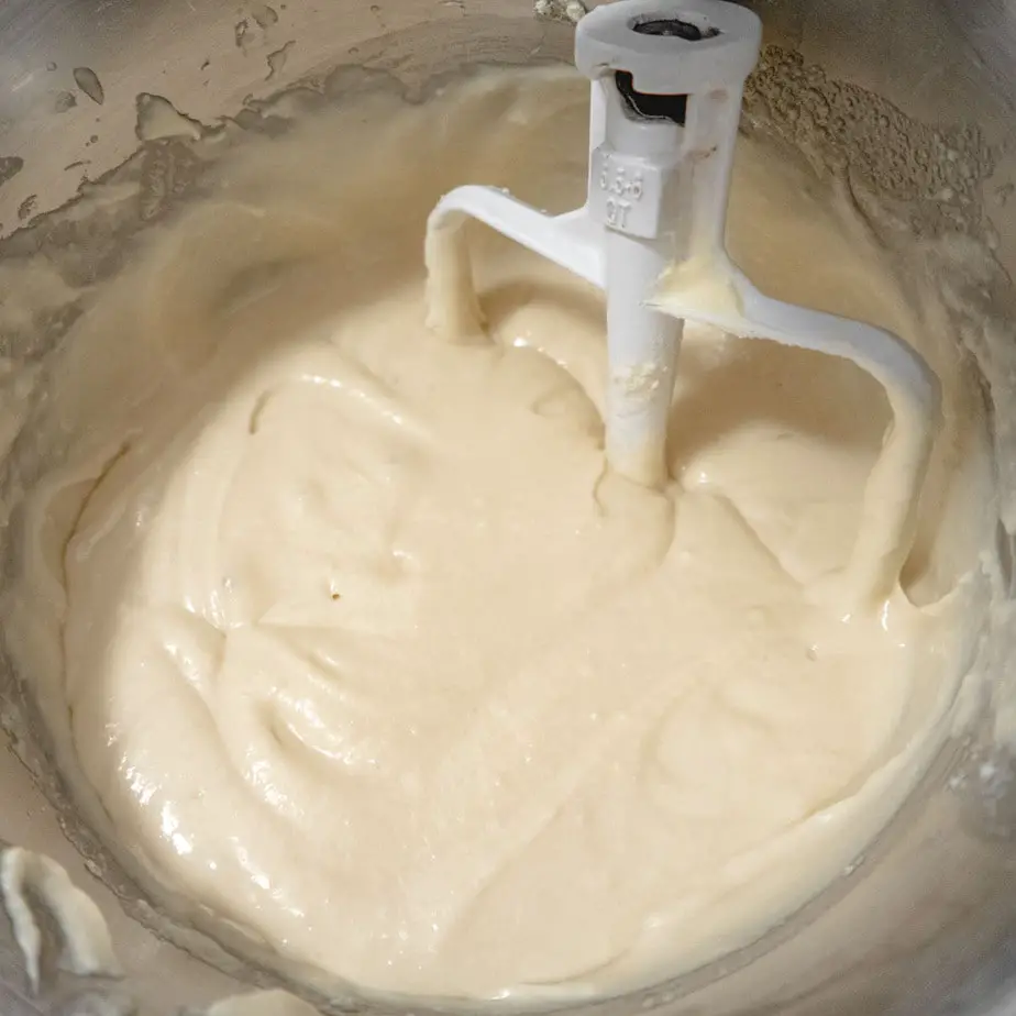 cake batter in a metallic bowl with a paddle attachment