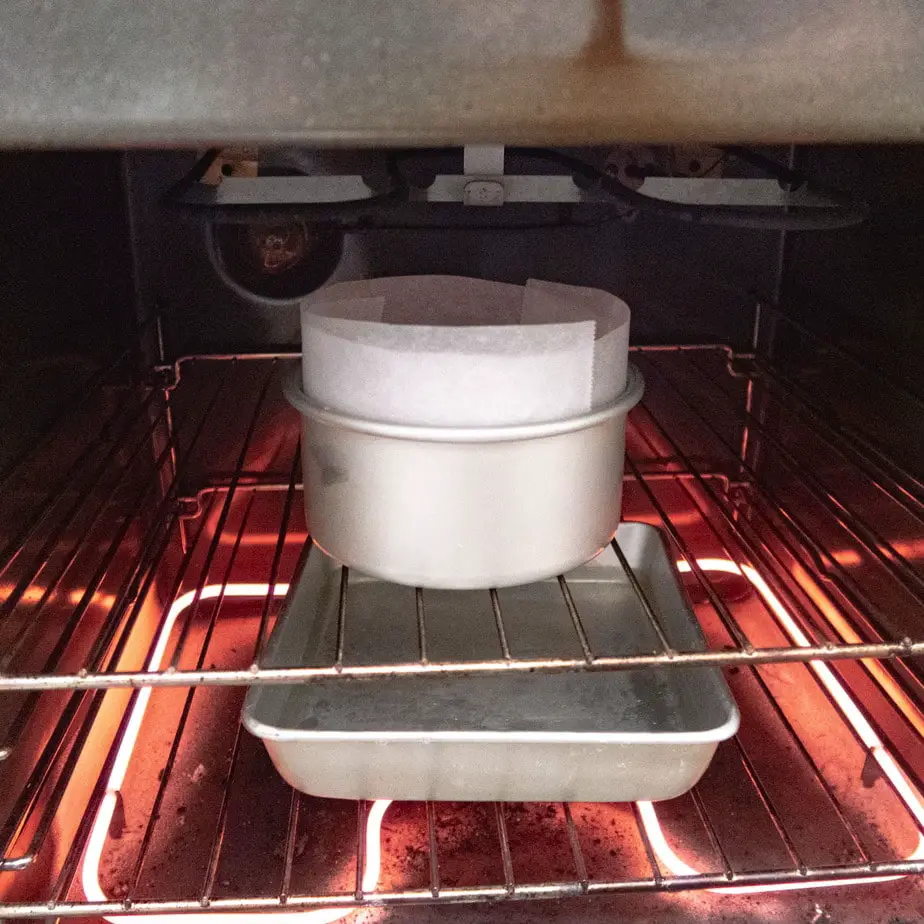 cake tin in the over with a dish filled with water on the oven rack underneath