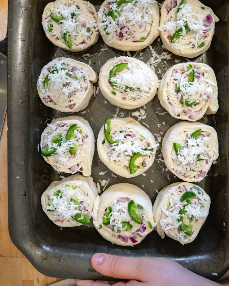 unbaked vegan savoury rolls in a baking dish ready for the oven