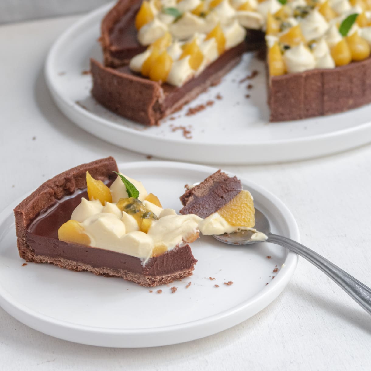 a slice of tart on a white plate in the process of being eaten