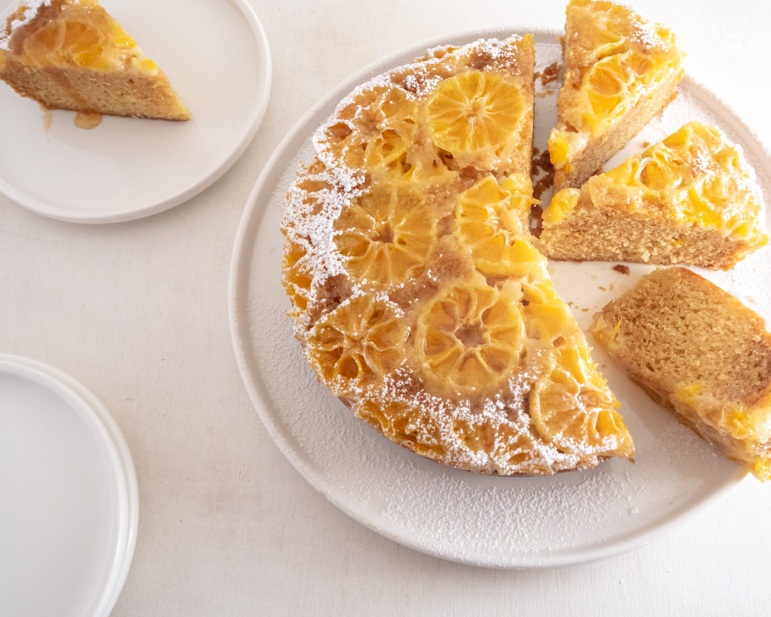 cake half sliced on a white plate and background