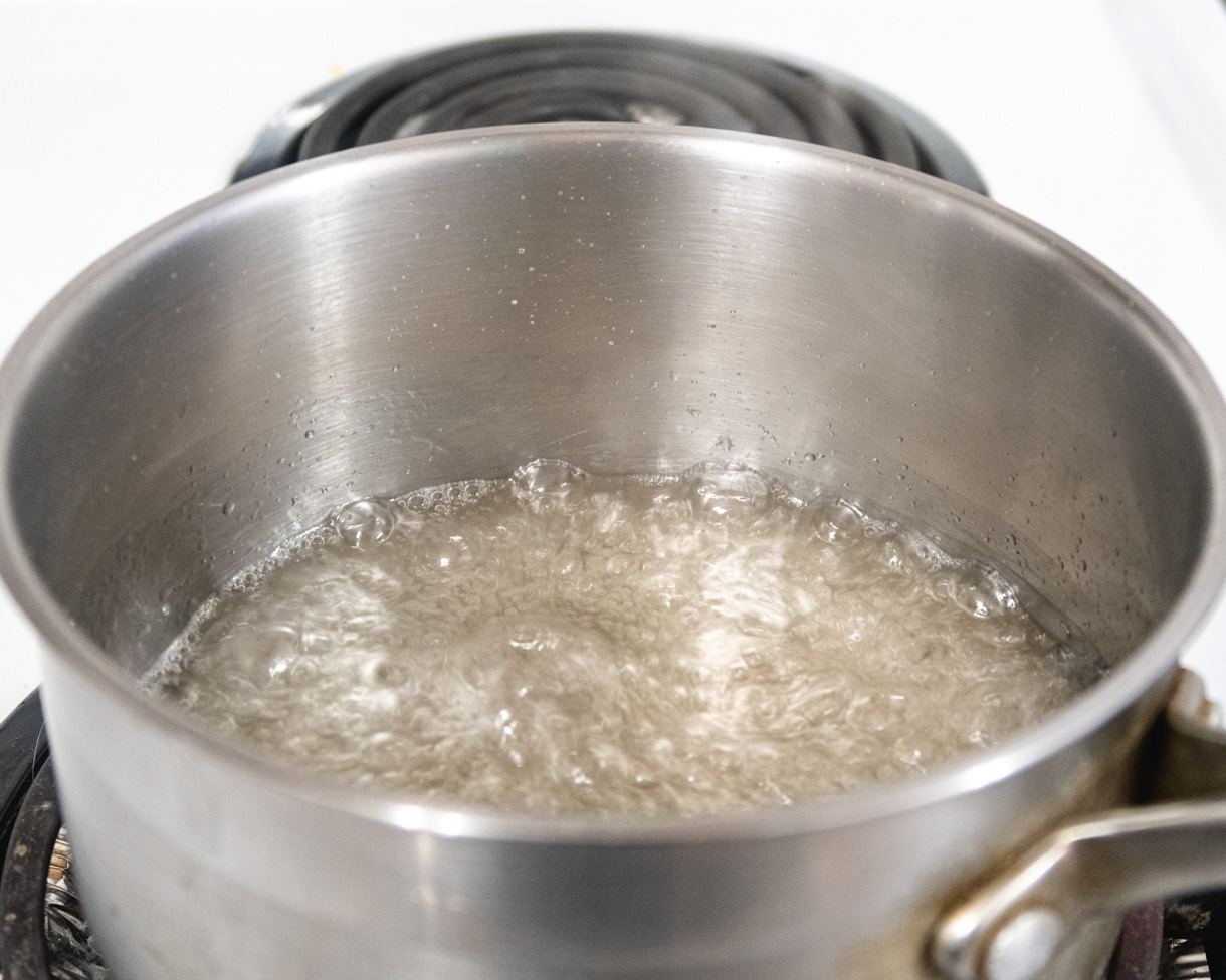 Boiling sugar syrup in a saucepan.