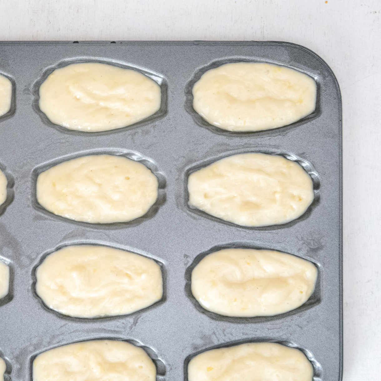 Filled madeleine baking tray viewed from the top.