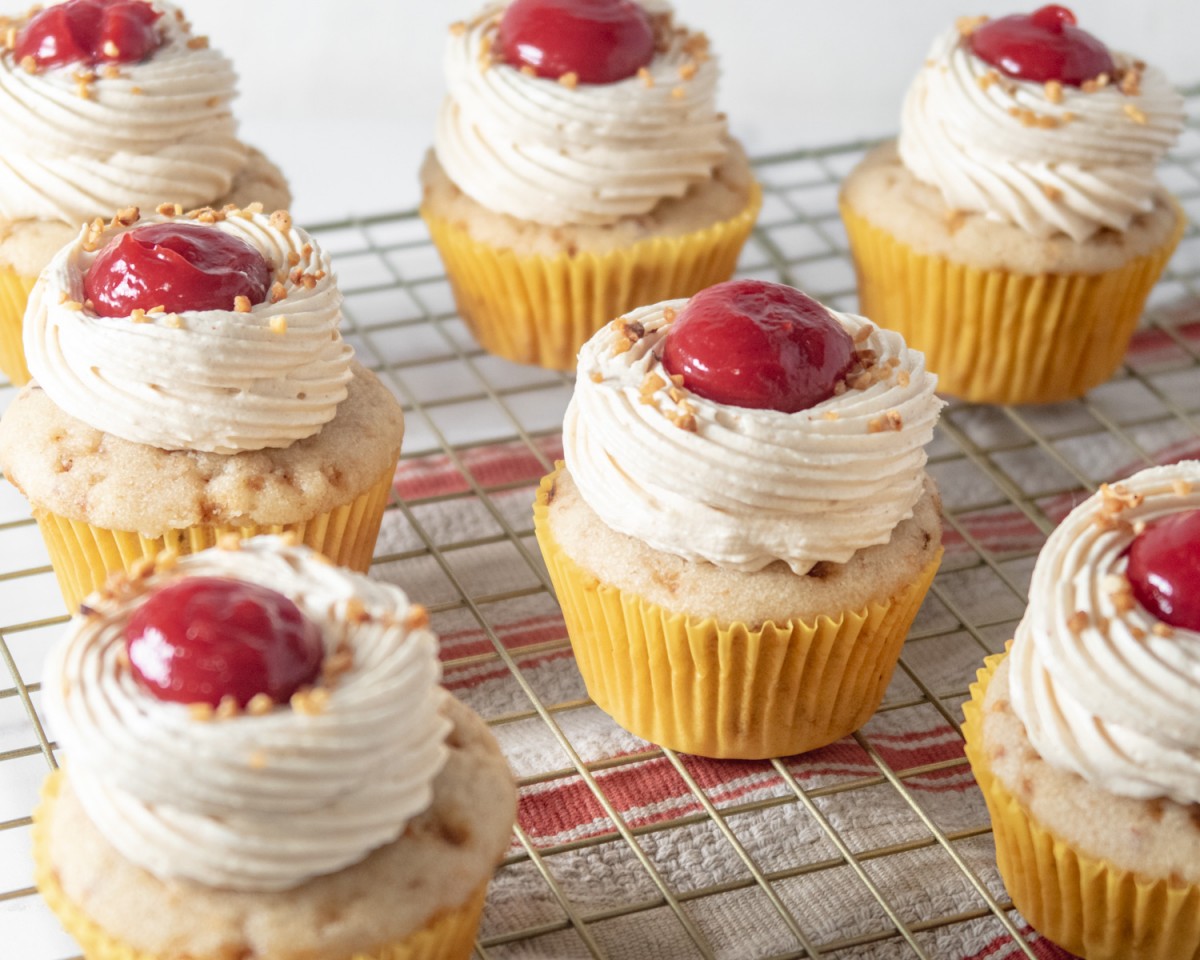 Vegan peanut butter and jelly cupcakes on a wire rack.