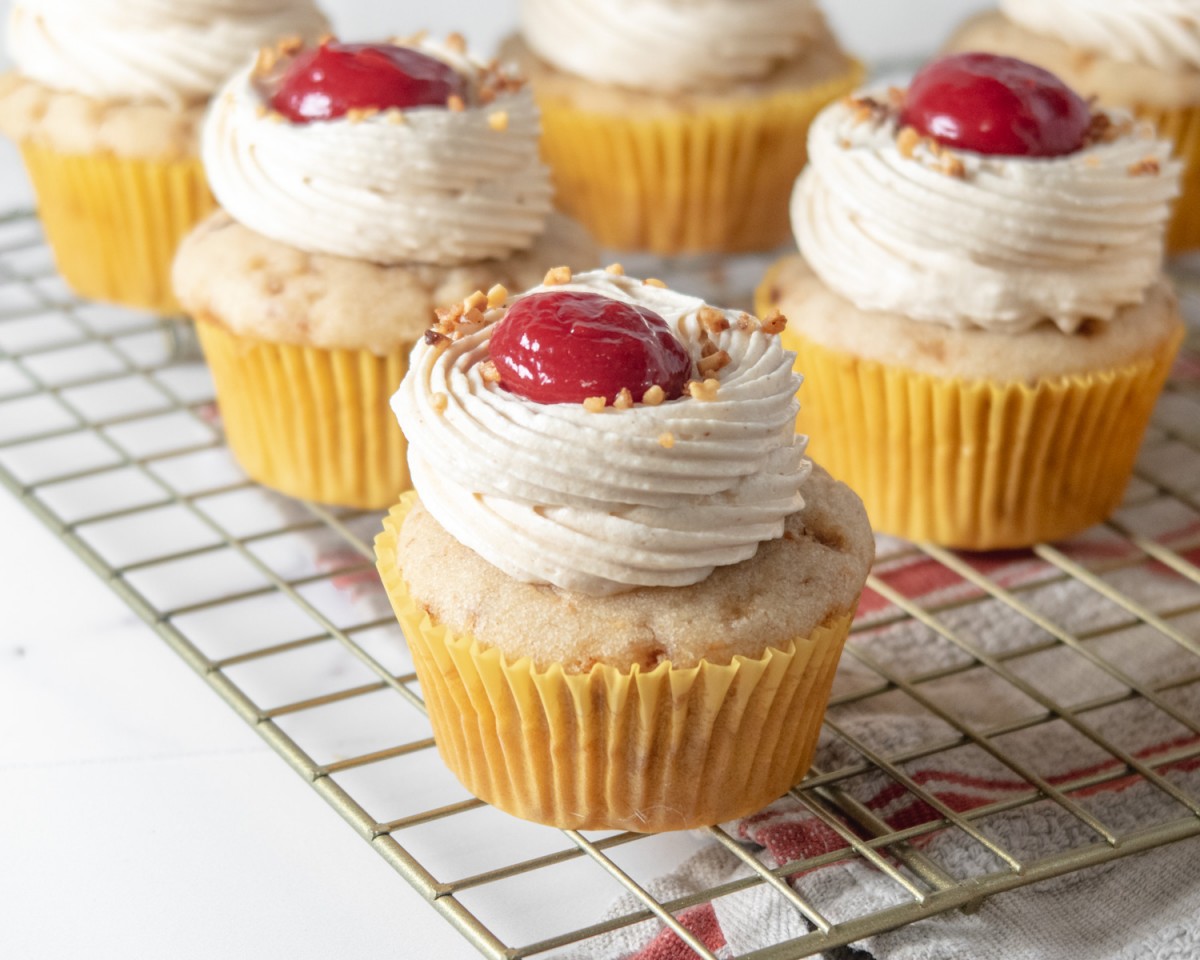 Vegan peanut butter and jelly cupcakes on a wire rack.