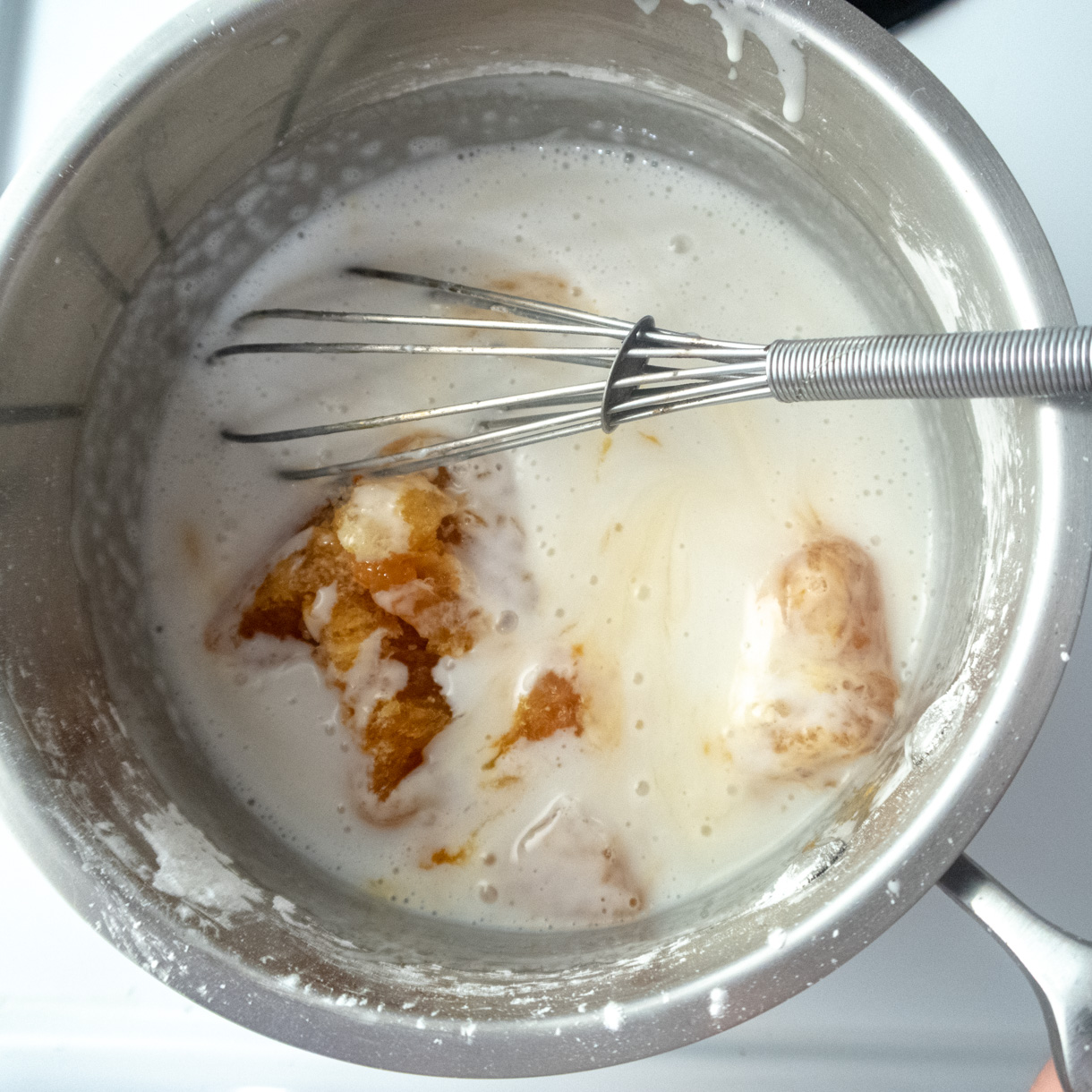 The ingredients of the passionfruit curd in a saucepan.