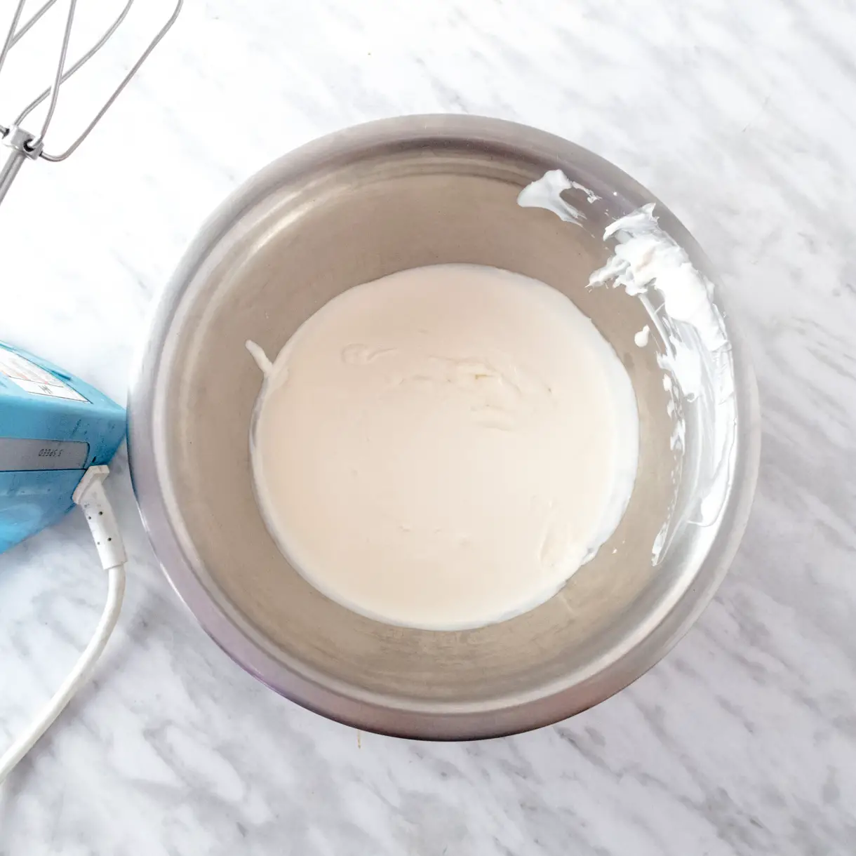 Vegan whipping cream (Ambiante by Puratos) liquid in a bowl before being whipped.