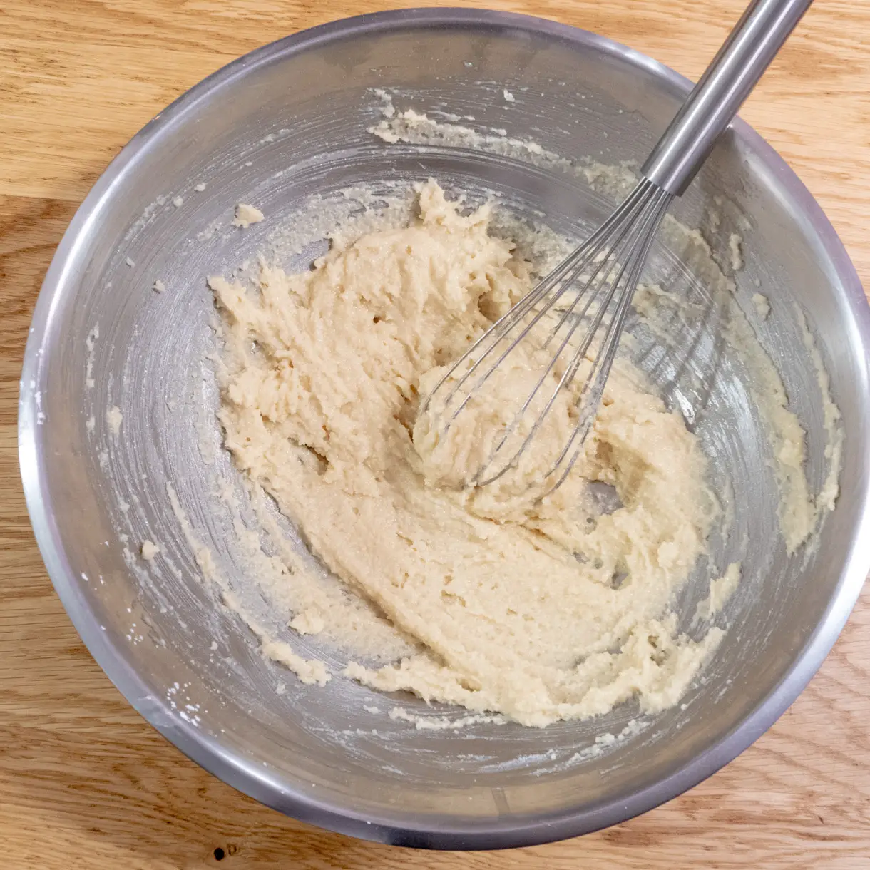 The stiff financier batter in a mixing bowl before adding the melted butter.