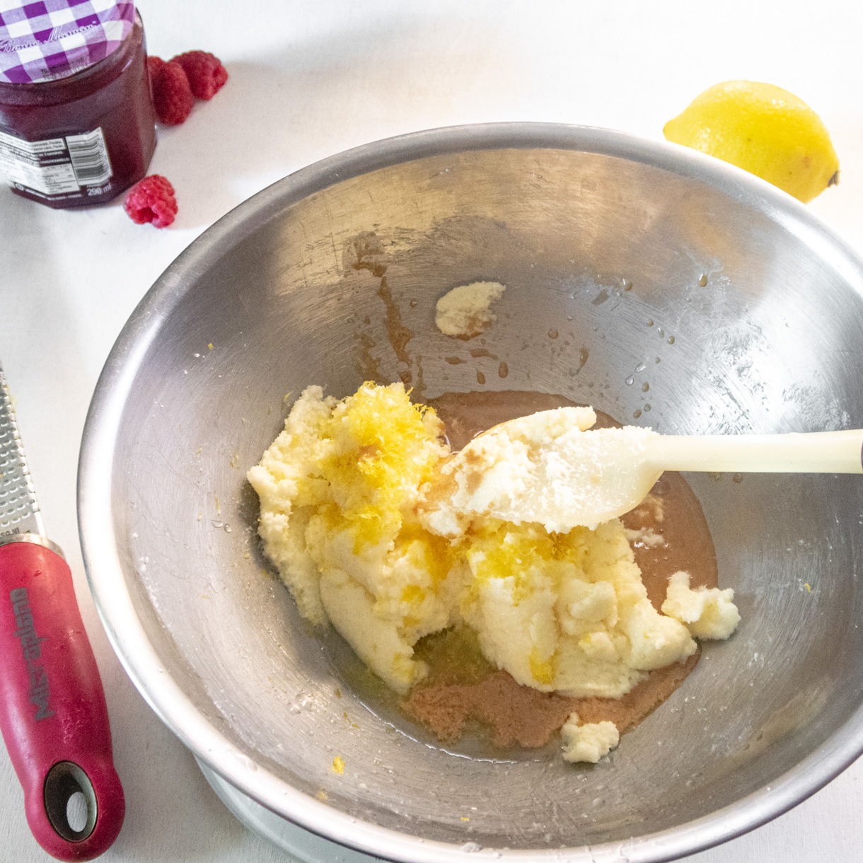 Creamed butter in a bowl with the rest of the wet ingredients before they get mixed in.