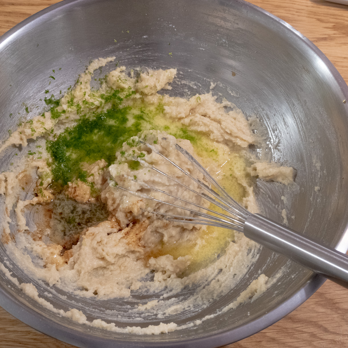 Lime zest, juice, vanilla and butter being incorporated into the batter.