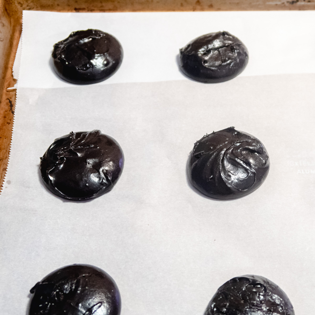 Cookie batter scooped on a baking tray.