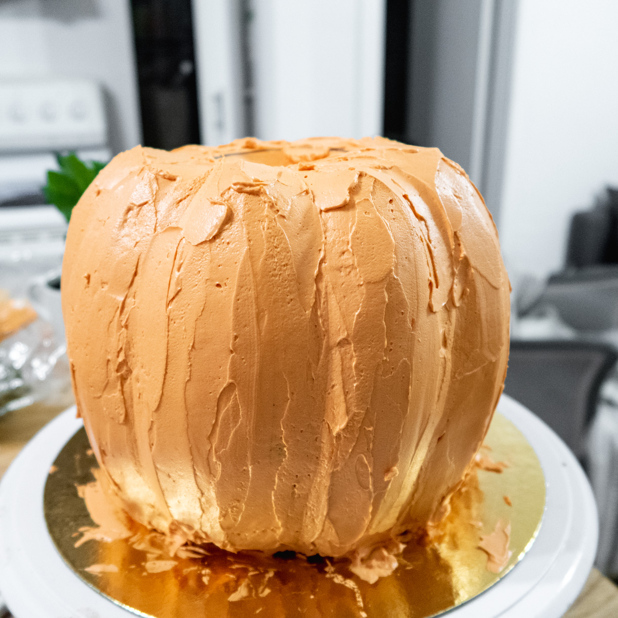 Smoothing out the buttercream while keeping the pumpkin segments.