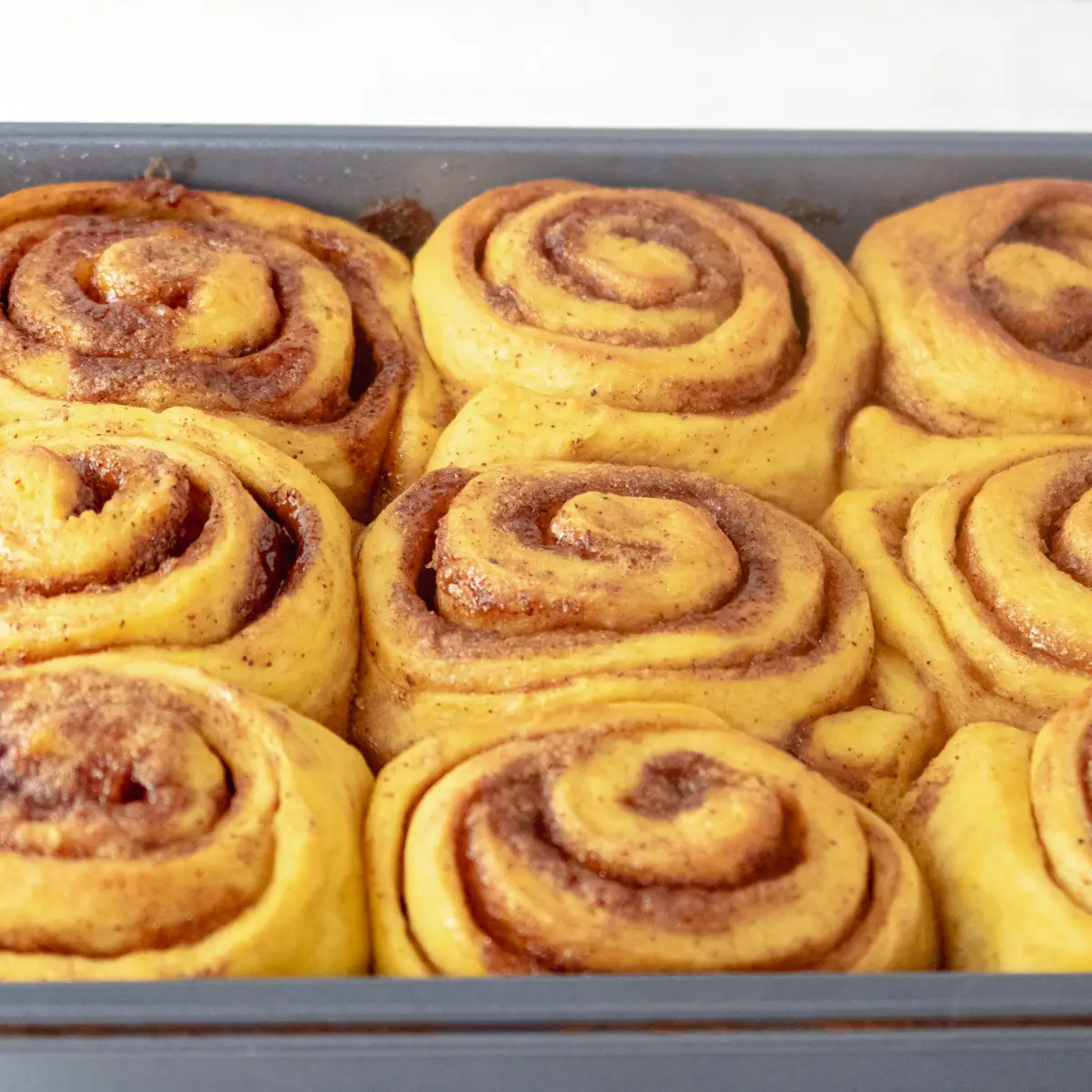 Vegan pumpkin cinnamon rolls fresh out of the oven before the drizzle.