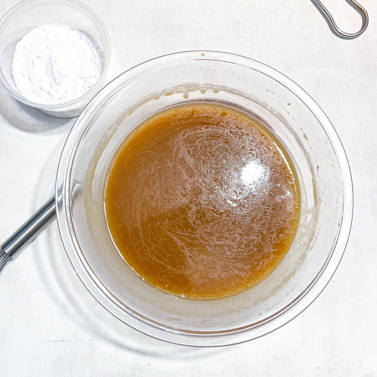 The sugar fudge mixture once cooked with a bowl of powdered sugar next to it