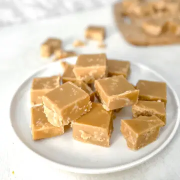 Vegan sucre à la crème squares stacked on a plate.