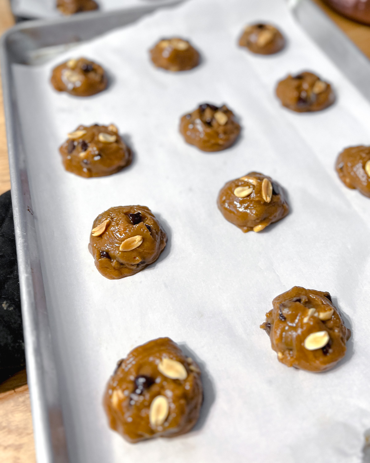 Raw vegan peanut butter chocolate chip cookies in a baking tray.