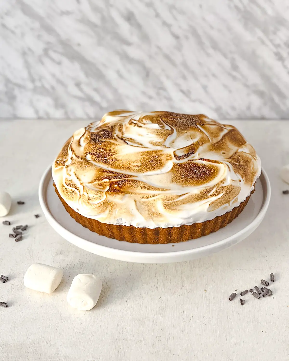 Vegan s'more tart with chocolate ganache and toasted marshmallow topping.